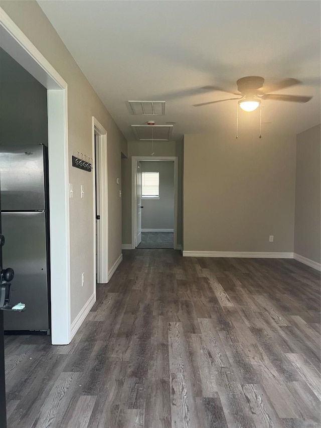 4409 Saint Goar St, Dickinson, TX 77539 - empty room featuring attic access, dark wood-type flooring, baseboards, and a ceiling fan