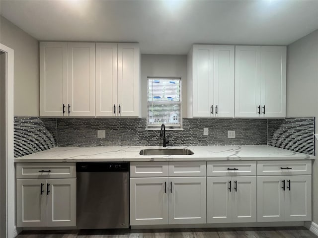 4409 Saint Goar St, Dickinson, TX 77539 - kitchen featuring dishwasher, a sink, white cabinetry, and backsplash