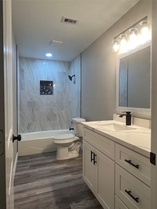 4409 Saint Goar St, Dickinson, TX 77539 - bathroom featuring wood finished floors, toilet, vanity, shower / tub combination, and recessed lighting