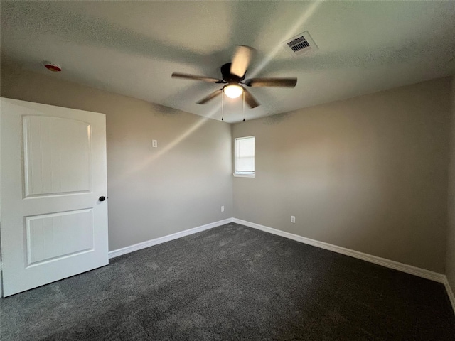 4409 Saint Goar St, Dickinson, TX 77539 - unfurnished room with a ceiling fan, baseboards, dark carpet, and a textured ceiling