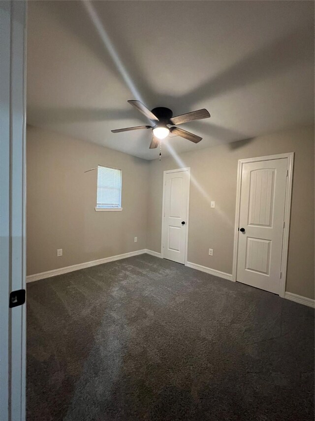 4409 Saint Goar St, Dickinson, TX 77539 - unfurnished room featuring ceiling fan, dark colored carpet, and baseboards