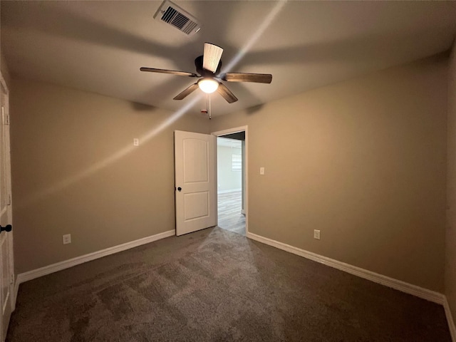 4409 Saint Goar St, Dickinson, TX 77539 - unfurnished room with ceiling fan, dark colored carpet, and baseboards