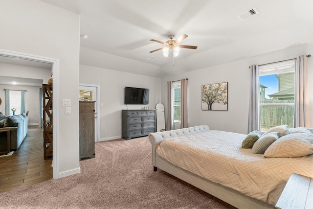 bedroom with visible vents, carpet, and multiple windows