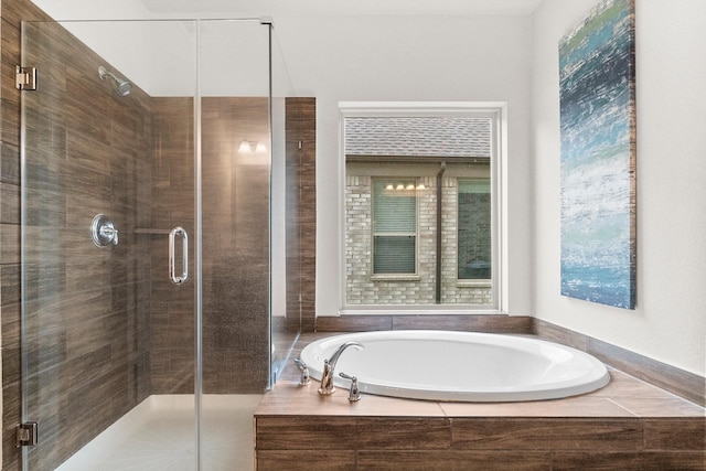 full bathroom featuring a garden tub and a stall shower