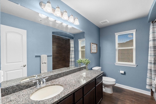 full bath with baseboards, wood finished floors, visible vents, and toilet