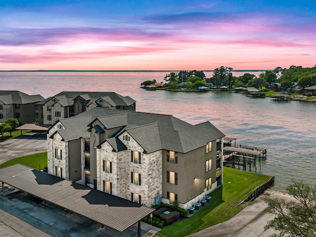 aerial view at dusk with a water view