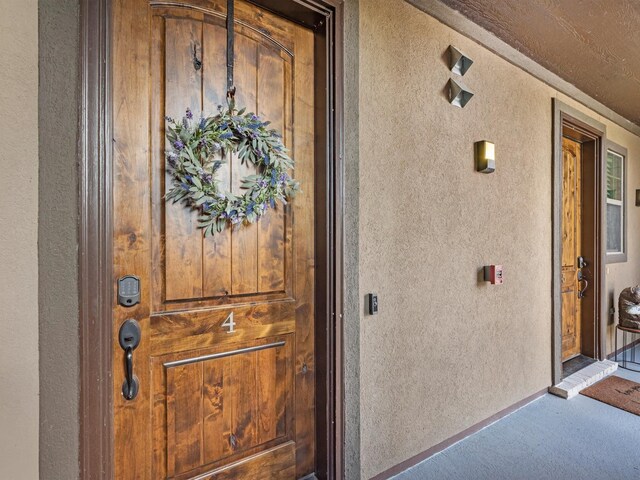 entrance to property featuring stucco siding
