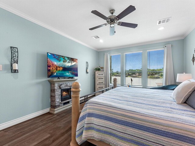 bedroom featuring baseboards, ornamental molding, wood finished floors, and visible vents