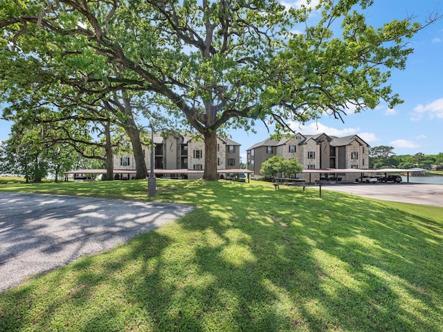 2112 Fm 3186 Unit C4, Onalaska, TX 77360 - view of front facade featuring a front lawn and a residential view