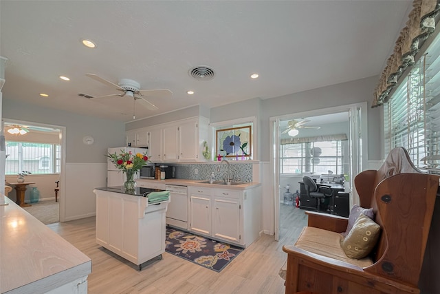 kitchen with white dishwasher, a sink, ceiling fan, and fridge