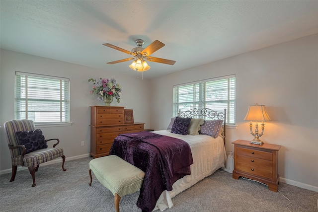 bedroom with baseboards, a ceiling fan, and light carpet
