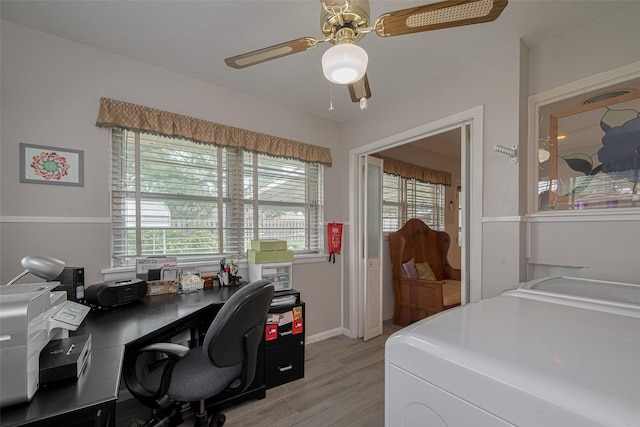 home office with washer / dryer, plenty of natural light, a ceiling fan, and light wood-type flooring