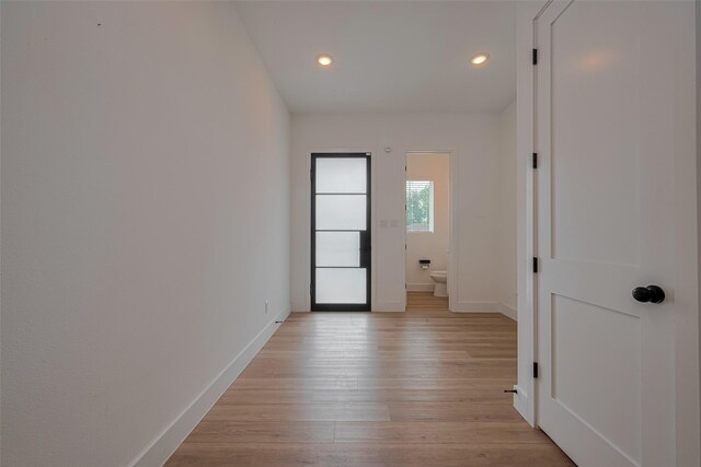 hallway with recessed lighting, baseboards, and light wood-type flooring