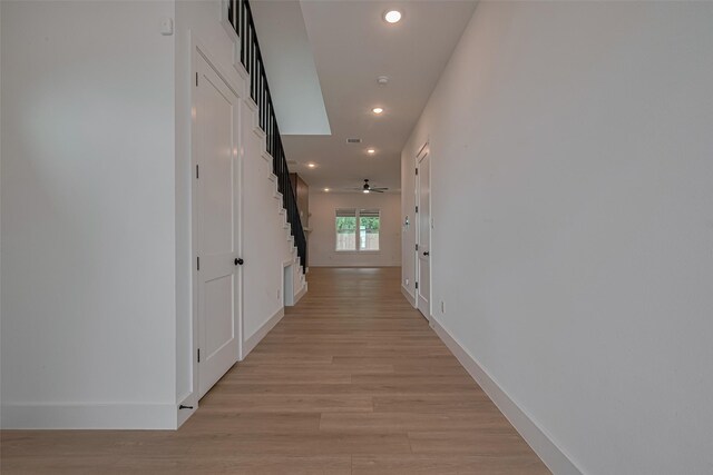 hallway with recessed lighting, baseboards, visible vents, and light wood-style floors