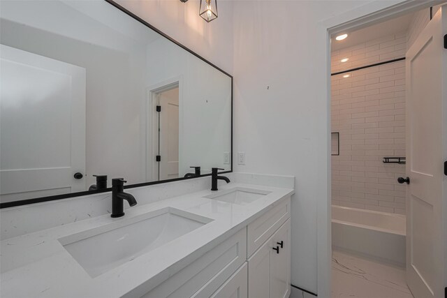 bathroom featuring a sink, shower / bath combination, double vanity, and marble finish floor