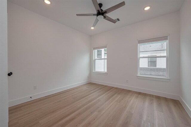 empty room featuring ceiling fan, light wood finished floors, recessed lighting, baseboards, and visible vents