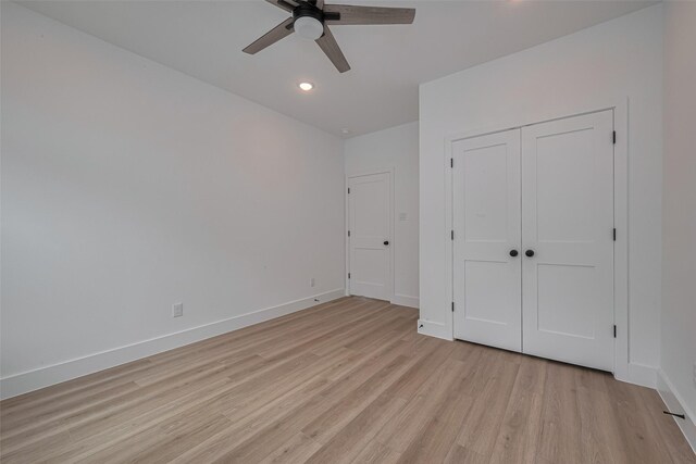 unfurnished bedroom with a closet, baseboards, recessed lighting, a ceiling fan, and light wood-style flooring