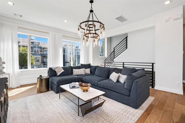 living room with recessed lighting, a notable chandelier, wood finished floors, and visible vents