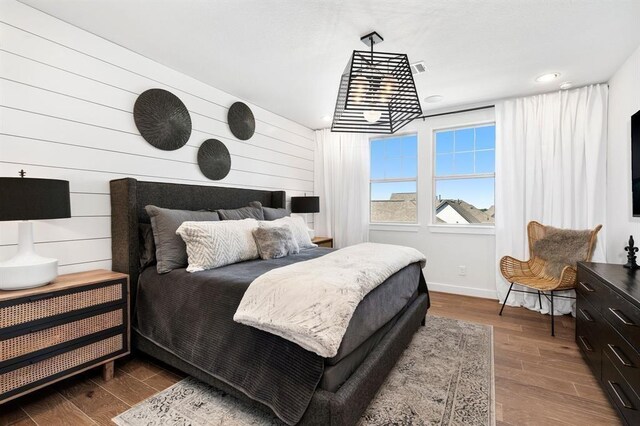 bedroom with baseboards, recessed lighting, and wood finished floors