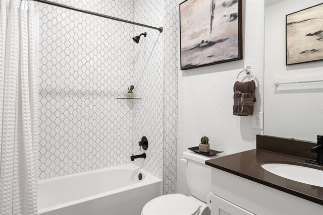 bathroom featuring toilet, shower / bathtub combination with curtain, and vanity