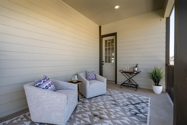 sitting room featuring recessed lighting and wooden walls
