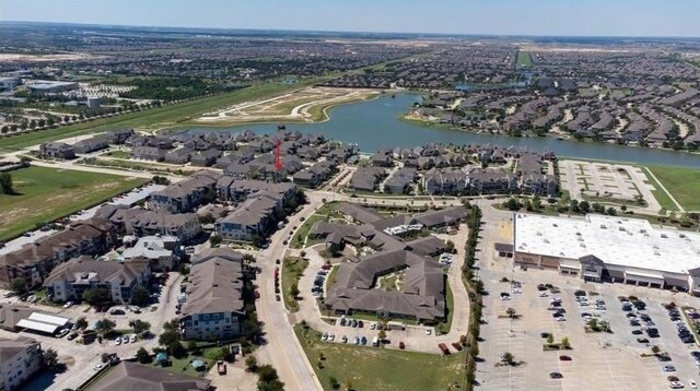 drone / aerial view featuring a residential view and a water view