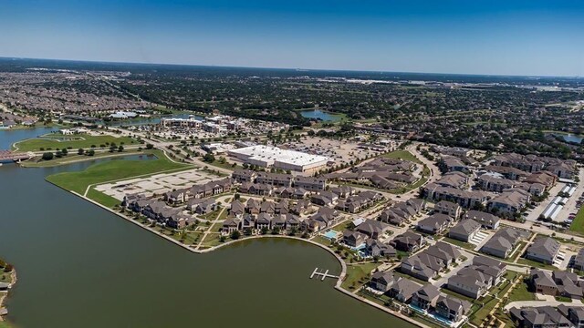 drone / aerial view featuring a water view and a residential view