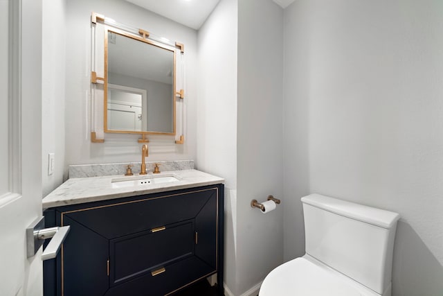 bathroom with toilet and vanity