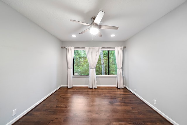 empty room with ceiling fan, wood finished floors, recessed lighting, and baseboards