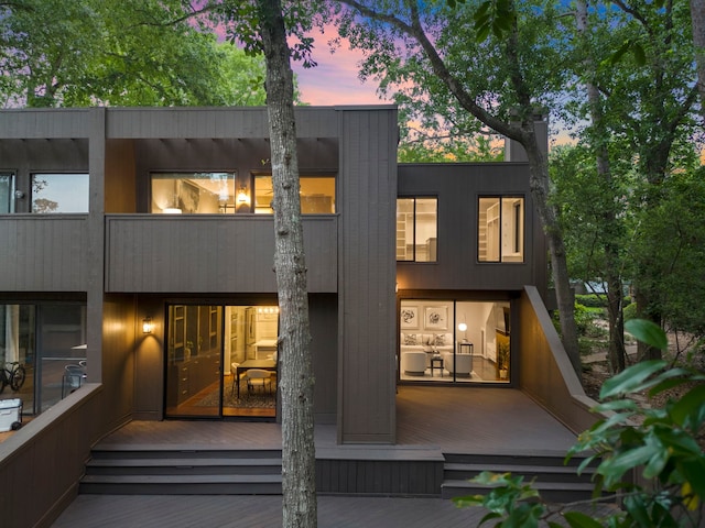 rear view of property featuring a balcony
