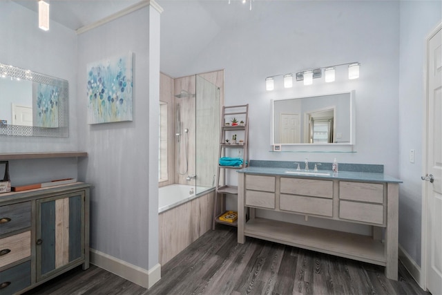 full bathroom featuring vaulted ceiling, wood finished floors, baseboards, vanity, and shower / bathtub combination