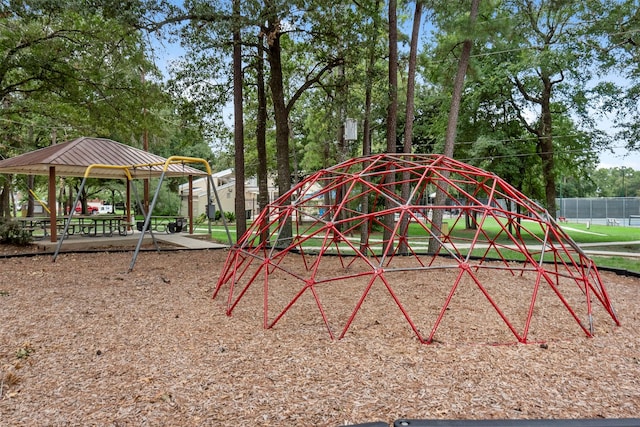 view of jungle gym featuring a gazebo and fence