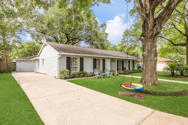single story home with concrete driveway, roof with shingles, and a front lawn