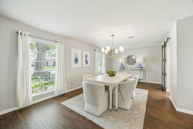 dining room with a wealth of natural light, dark wood finished floors, and a notable chandelier
