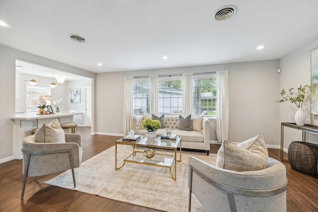 living area featuring dark wood-style flooring, visible vents, and recessed lighting