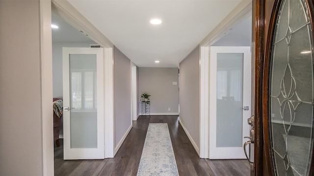 corridor with dark wood-type flooring, recessed lighting, baseboards, and visible vents