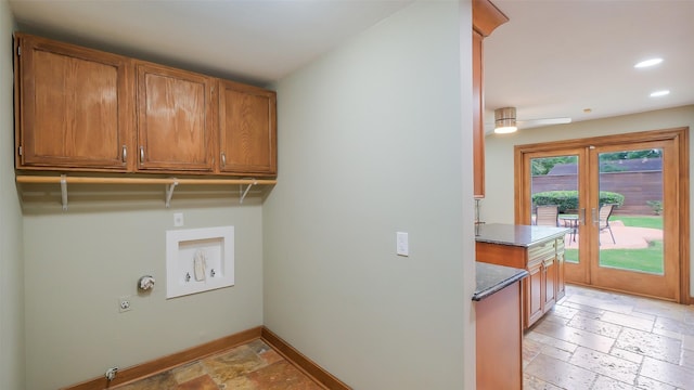 clothes washing area featuring electric dryer hookup, stone tile floors, baseboards, and recessed lighting