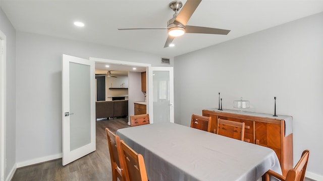 dining space featuring baseboards, a ceiling fan, wood finished floors, and visible vents