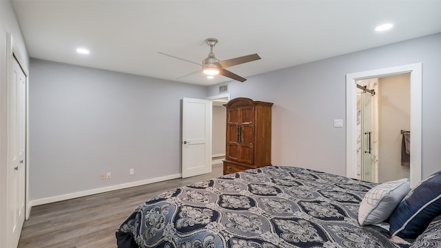 bedroom with recessed lighting, baseboards, wood finished floors, visible vents, and a closet