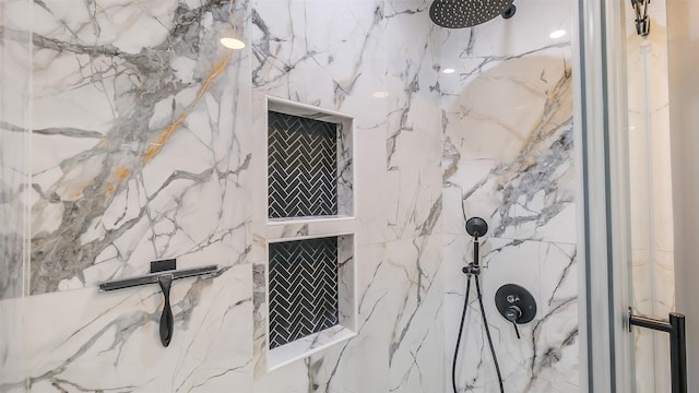 room details featuring a marble finish shower