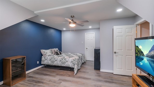 bedroom with recessed lighting, baseboards, and wood finished floors