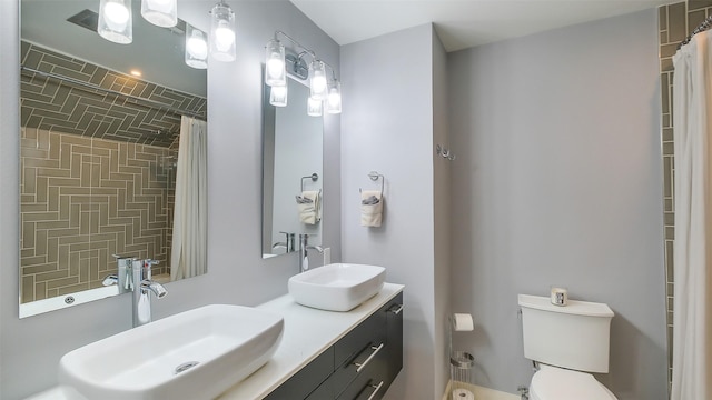full bathroom with a shower with shower curtain, toilet, a sink, and double vanity