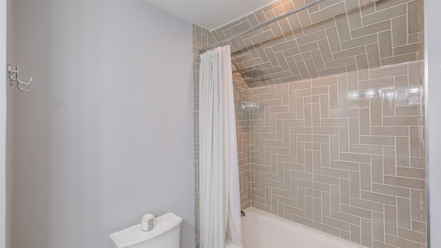bathroom with toilet and shower / bath combination with curtain