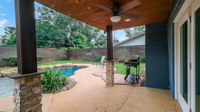 view of patio / terrace with a fenced backyard, a ceiling fan, and area for grilling