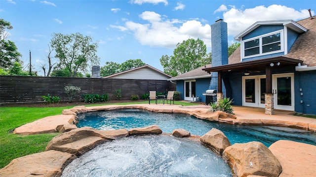 view of swimming pool featuring french doors, grilling area, a fenced backyard, and a patio area