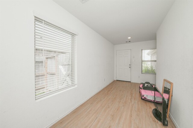 interior space with recessed lighting, wood finished floors, and visible vents