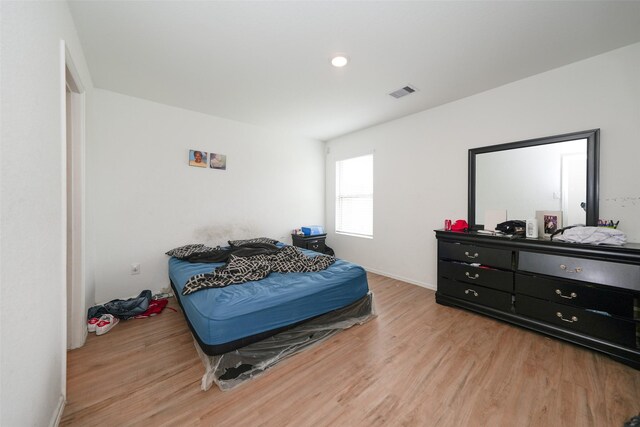 bedroom with visible vents and light wood finished floors