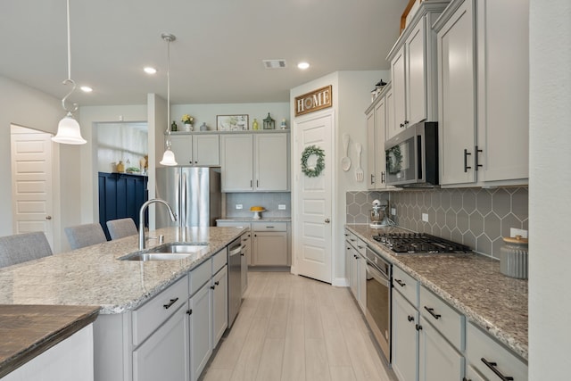 kitchen featuring stainless steel appliances, visible vents, a sink, and recessed lighting