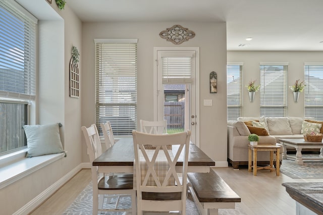 dining room featuring recessed lighting, baseboards, and light wood finished floors