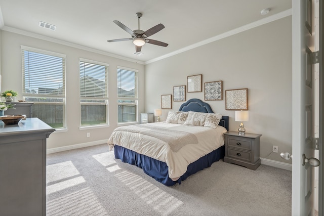 bedroom featuring crown molding, light colored carpet, a ceiling fan, baseboards, and visible vents